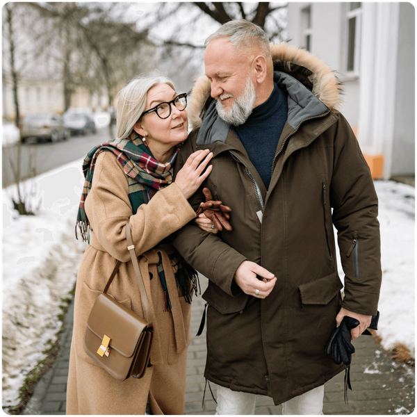 senior couple walking arm-in-arm