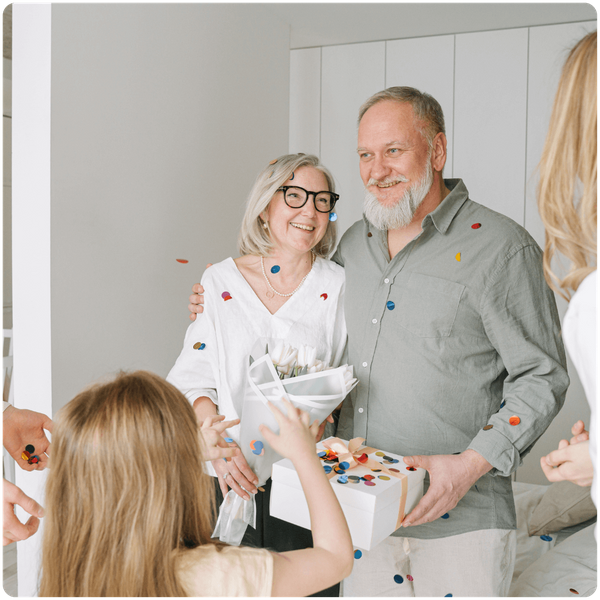 senior couple celebrating a special occasion with their family