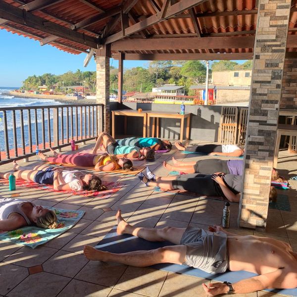 women doing yoga on pier