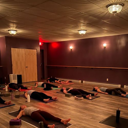 students laying down in hot yoga studio