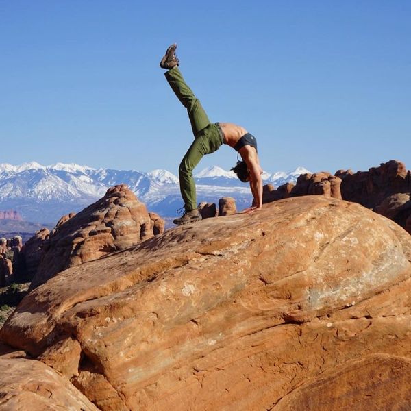 woman stretching on rock