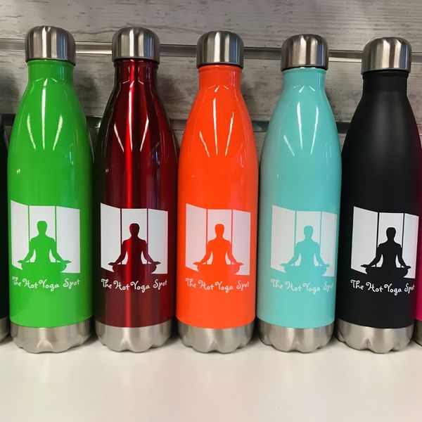 A close-up shot of five colorful Hot Yoga Spot branded reusable water bottles lined up on a shelf, featuring the studio's logo.