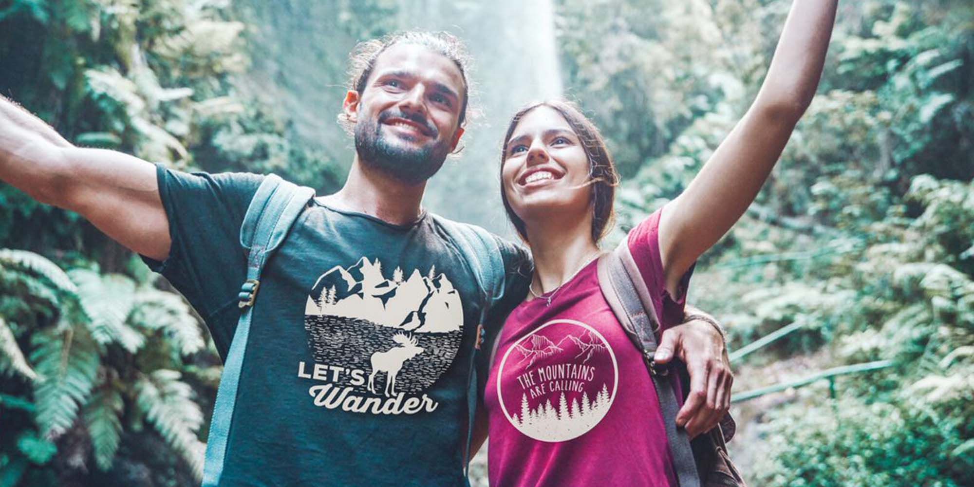 A couple wearing cool merch in the forest