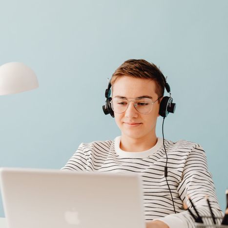 teenage boy on laptop with headphones