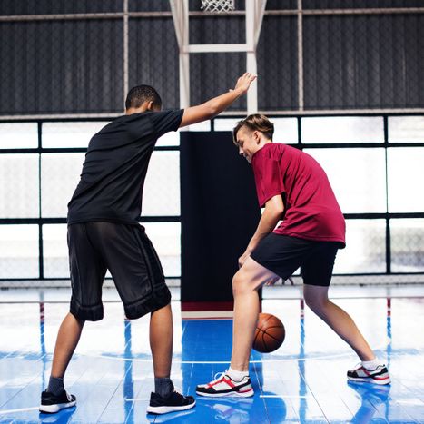 teenage boys playing basketball