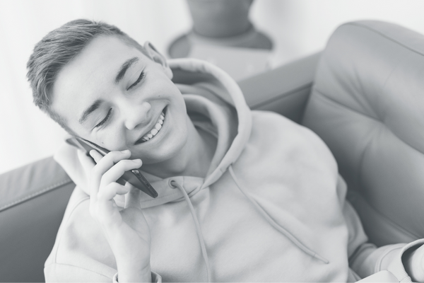 happy teen on phone call