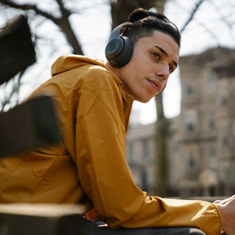 teen boy sitting outside on bench