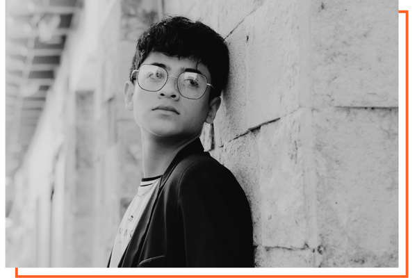 Young boy leaning against a wall Young boy leaning against a wall