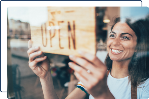 business owner changing sign to open