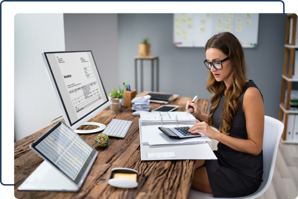 woman working on invoices at desk