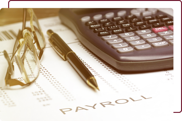 calculator next to a payroll sheet