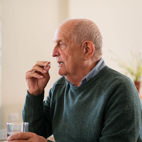 old man taking medicine