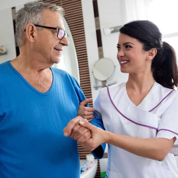 caregiver and senior walking together