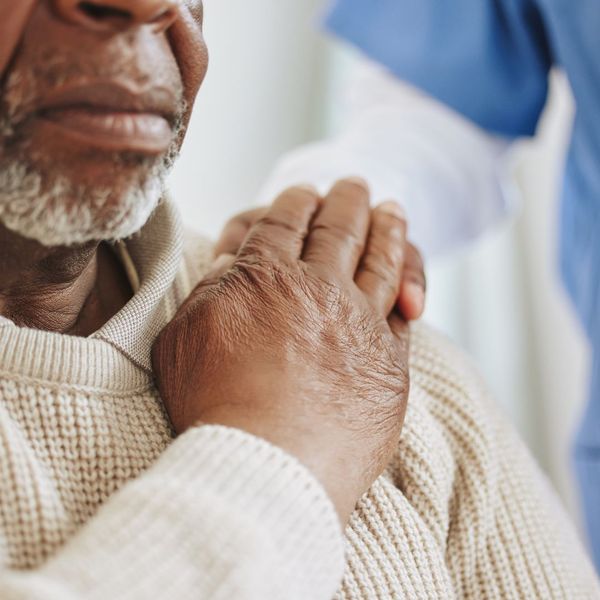 caregiver resting hand on senior's shoulder