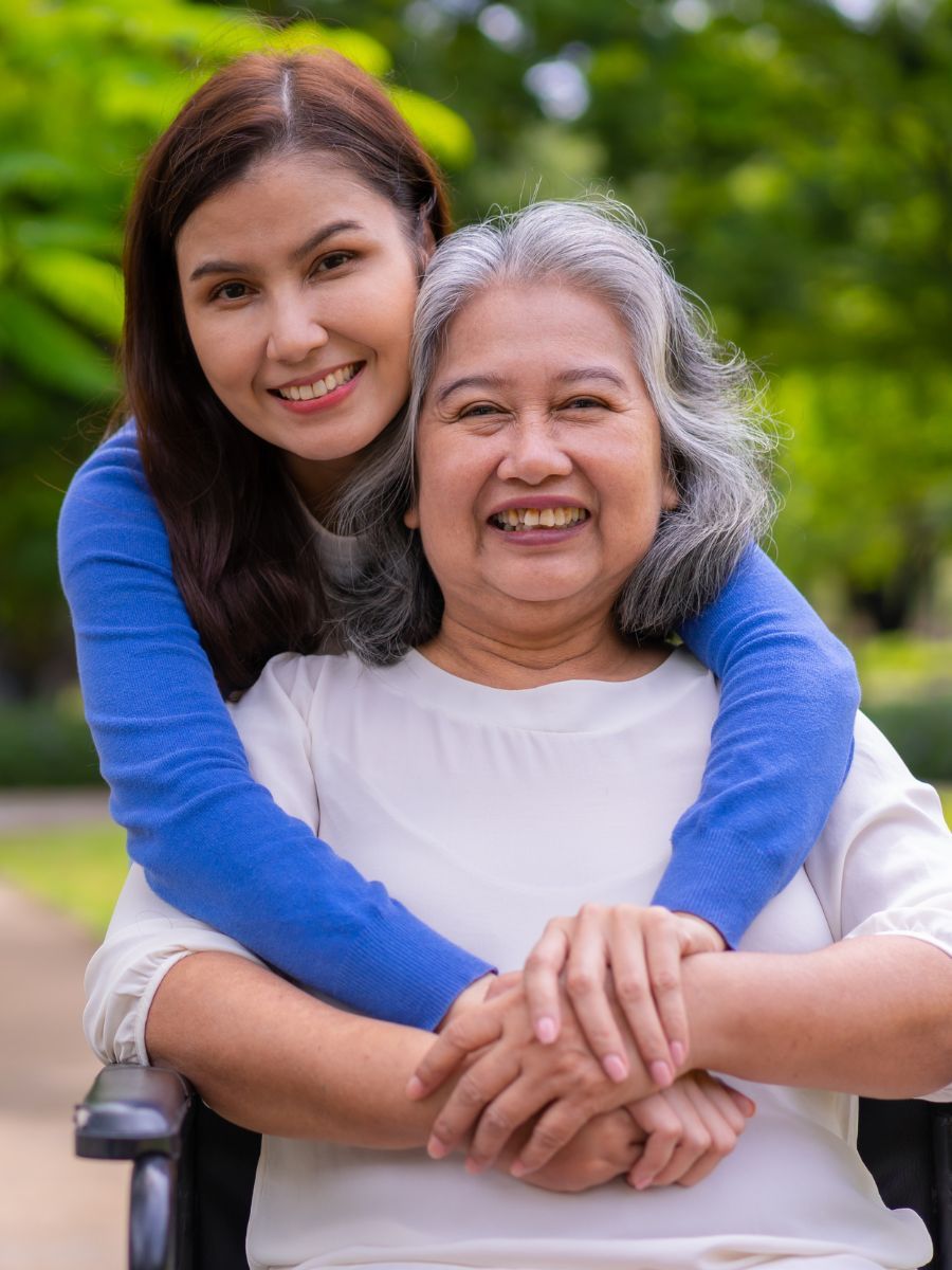 daughter hugging senior parent 