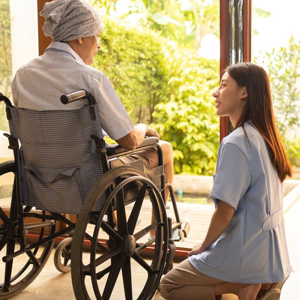 caregiver with woman in wheelchair 