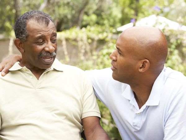 middle aged son spending time with senior father