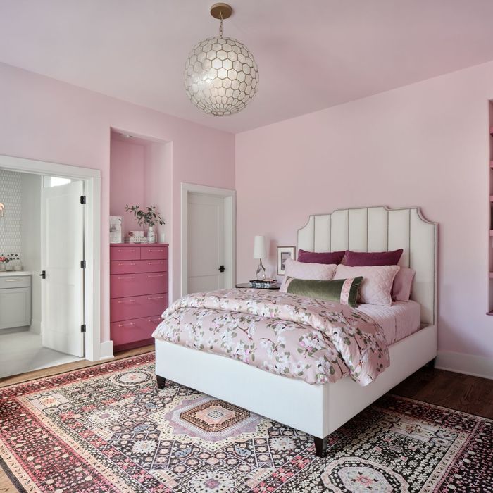 pink room with rug and white globe light