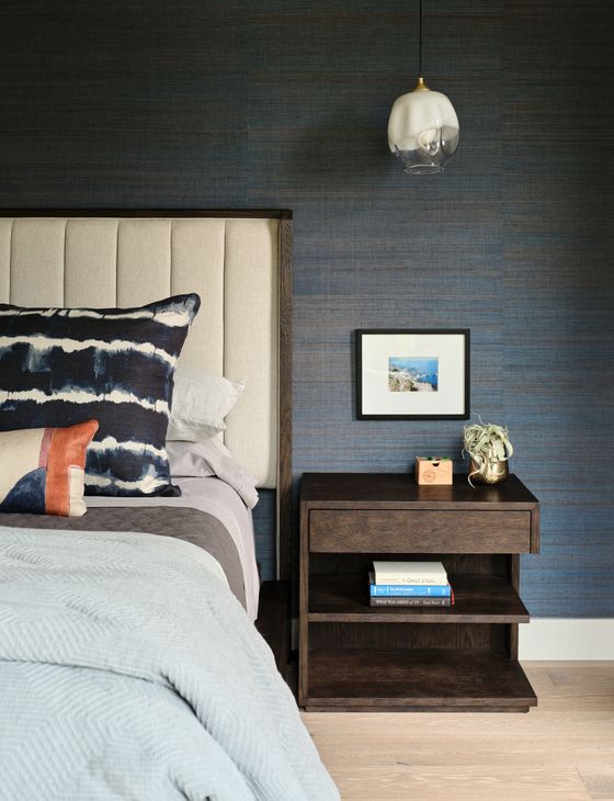 bedside table next to a bed with minimalist decorations