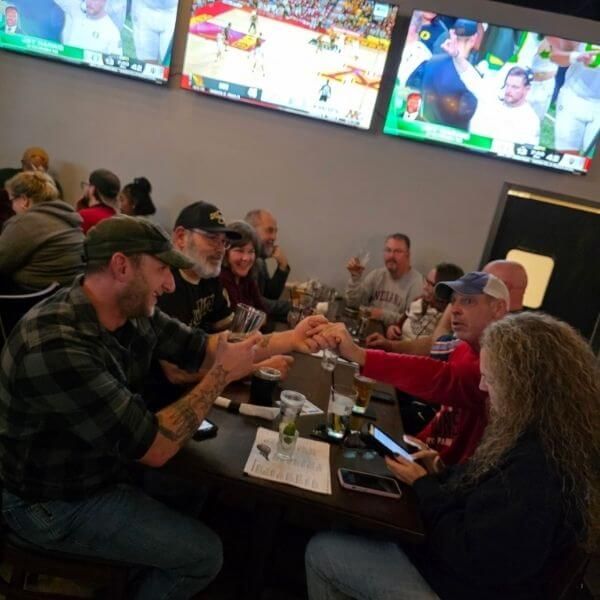Group of people taking shots and enjoying the game