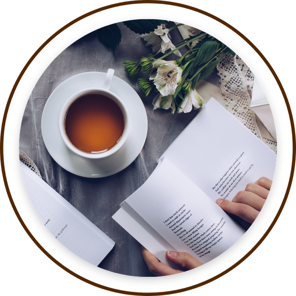 reading book while tea steeps, fresh flowers and lace nearby