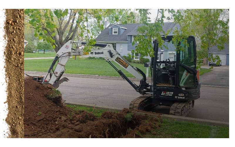 backhoe digging trench in front yard