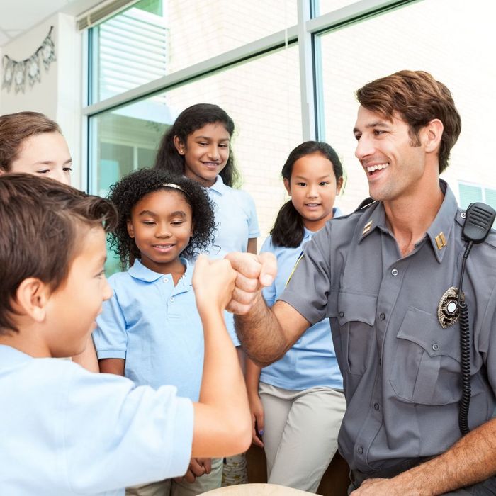 officer interacting with school kids