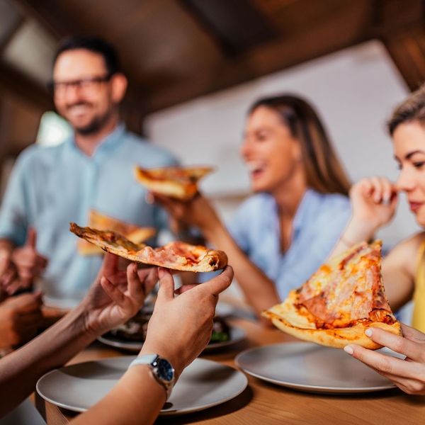 people eating pizza together