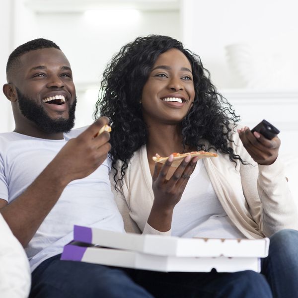 a couple enjoying pizza and a movie