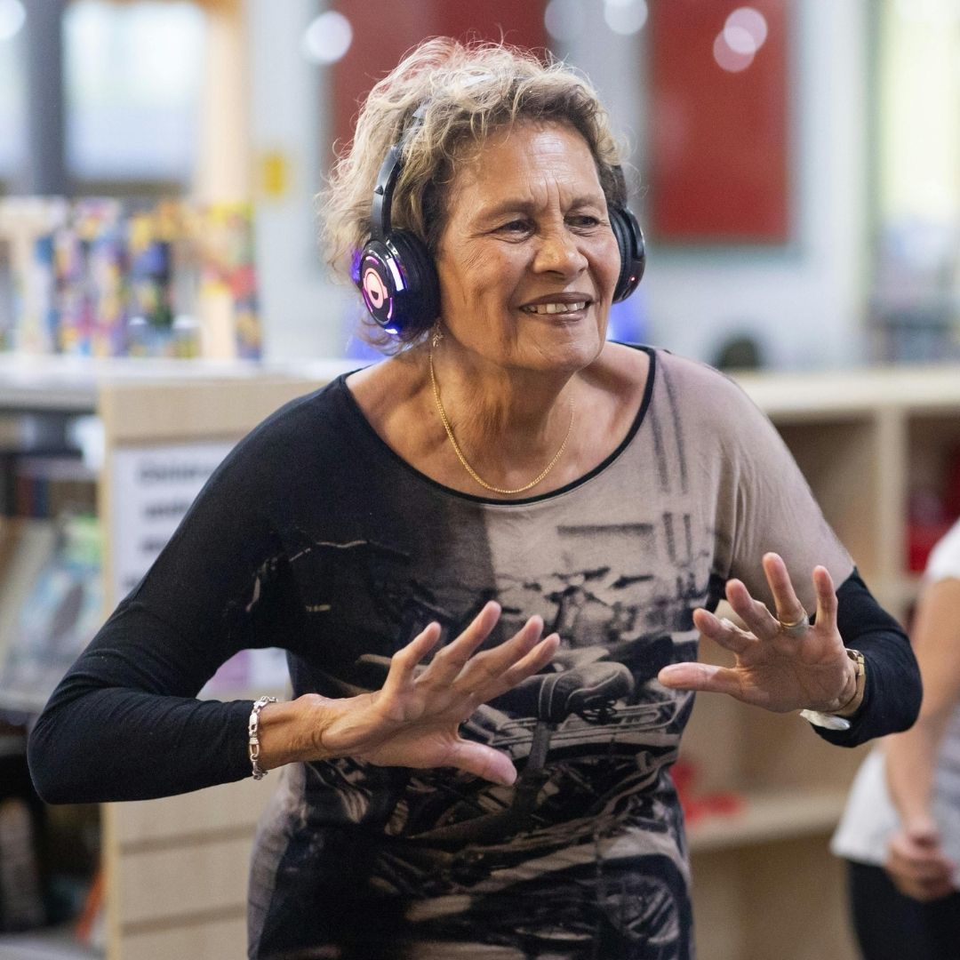 woman with headphones on laughing 