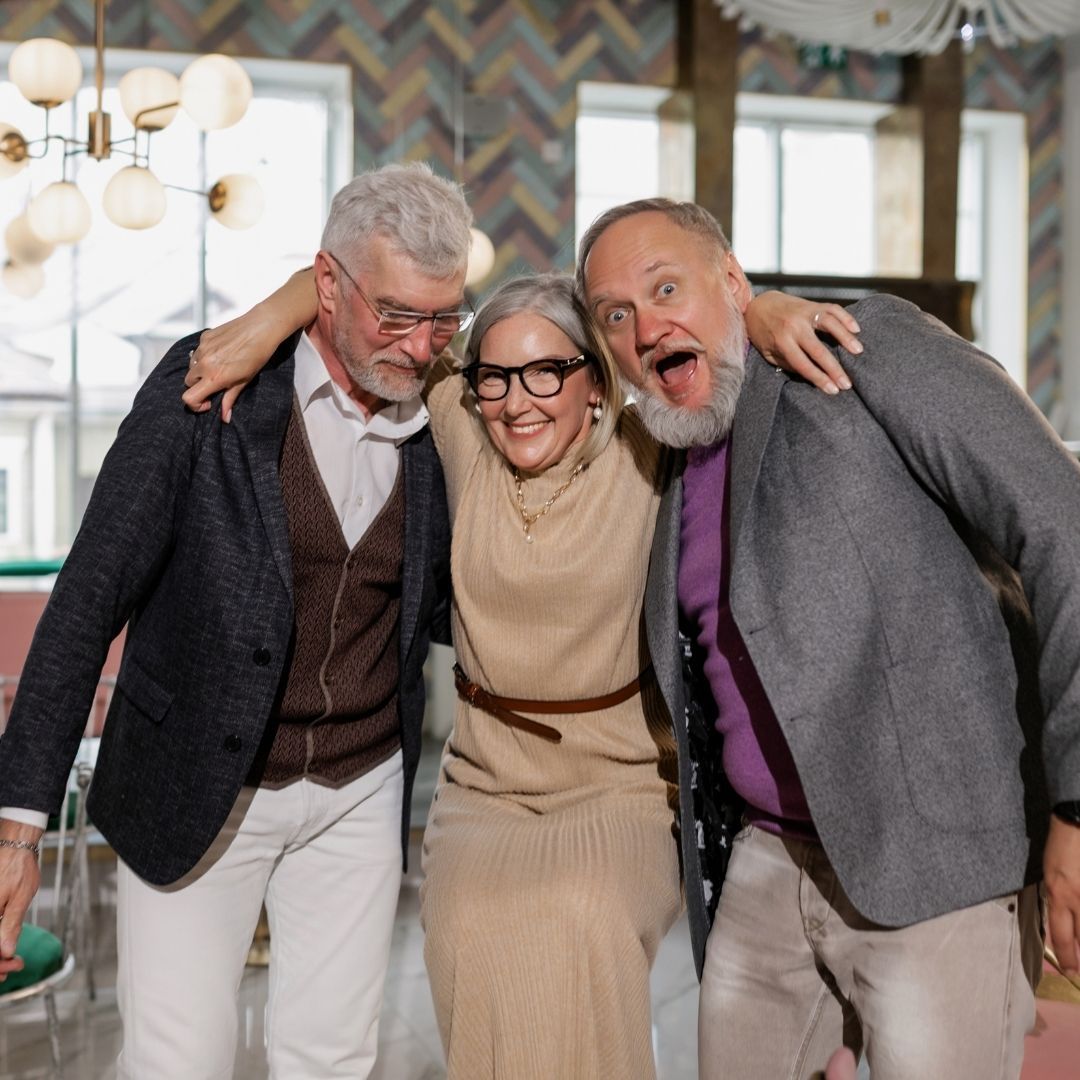 group of elderly friends laughing 