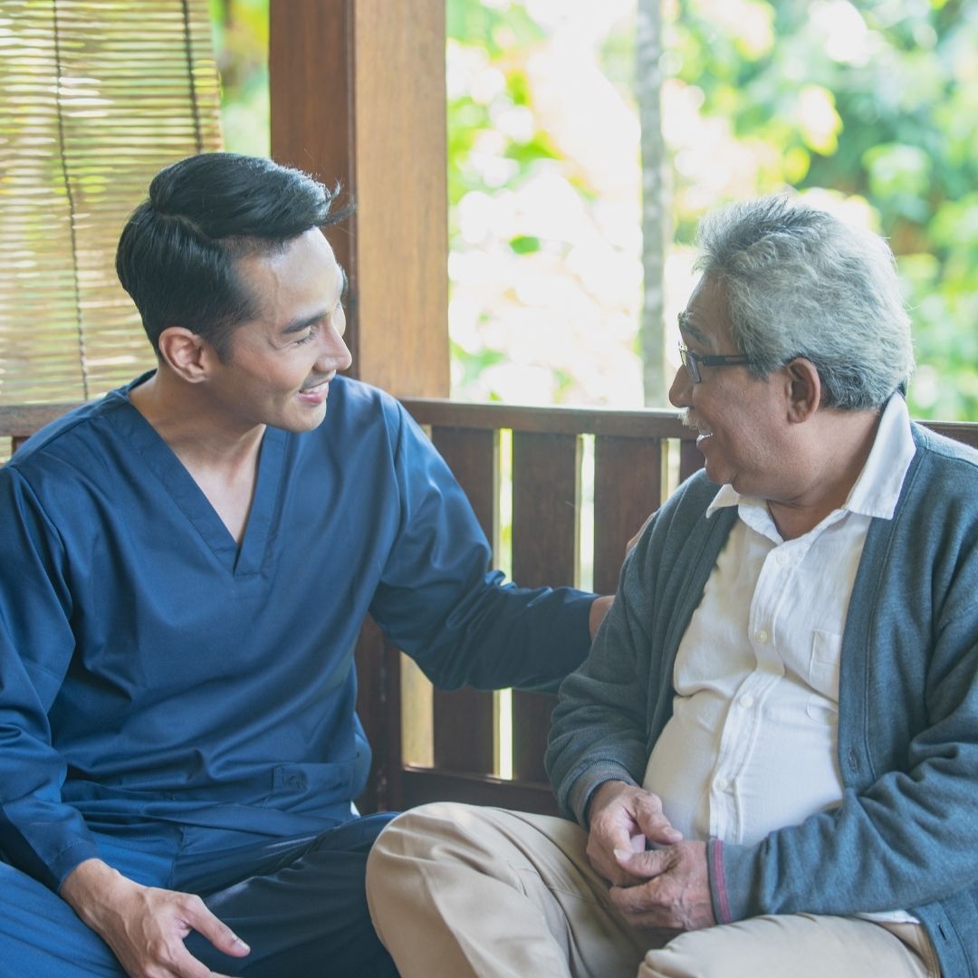 male nurse talking to assisted living client 