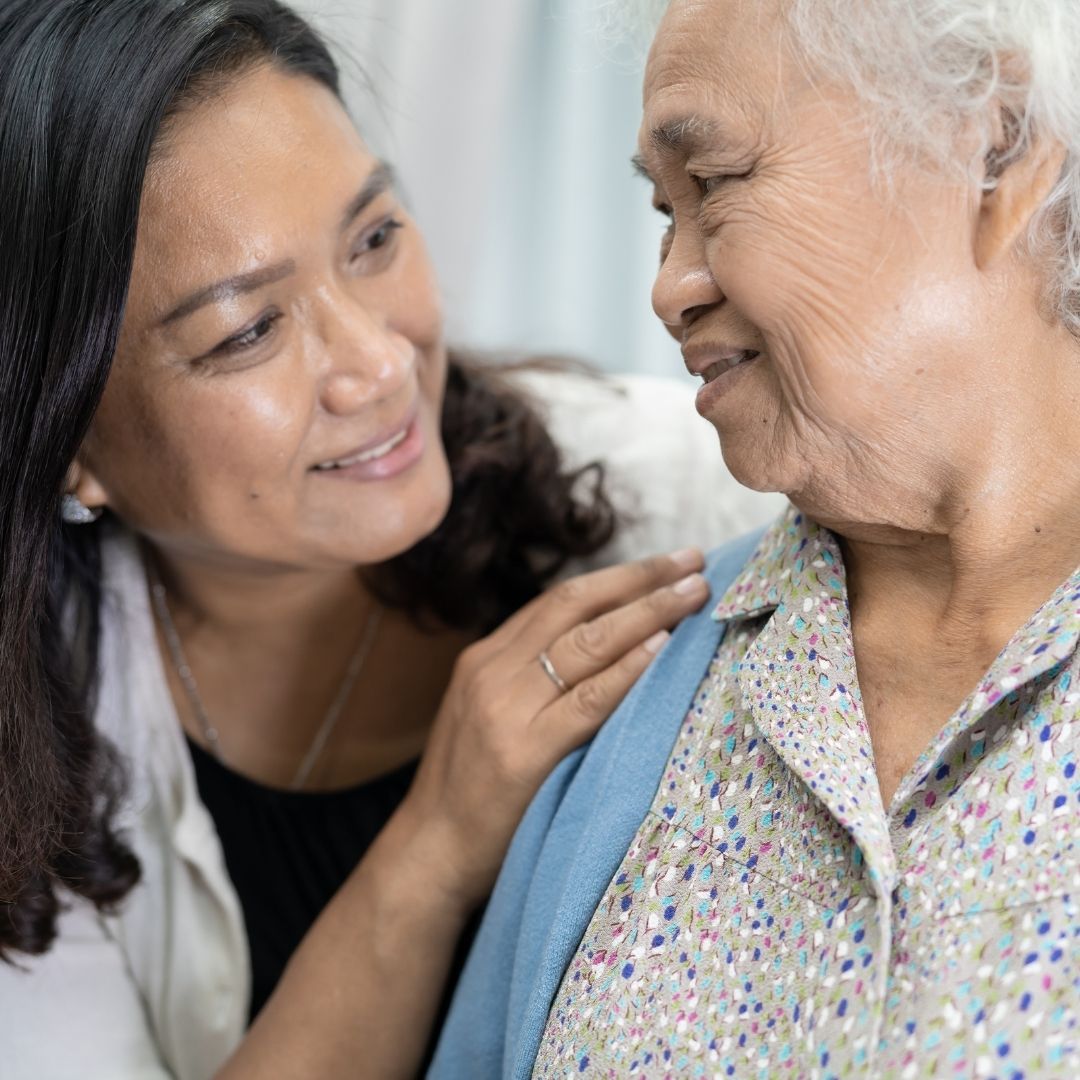 caring daughter looking at elderly mother 