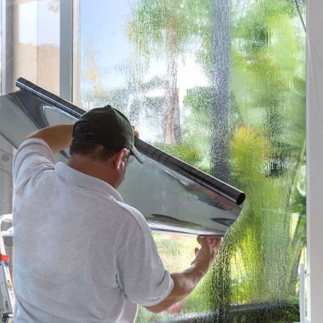 Technician installing residential window tint