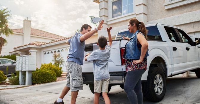 happy family loading pickup truck