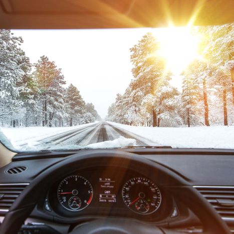 sun shining through windshield on winter drive