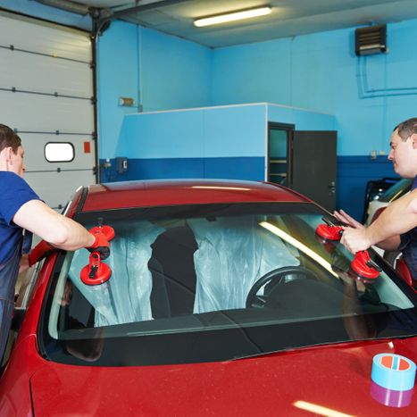 Two Technicians Replacing Windshield