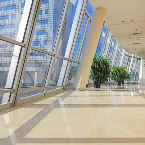 Large corridor with floor-to-ceiling windows in a commercial building 