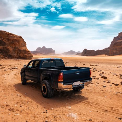 black truck driving through the desert