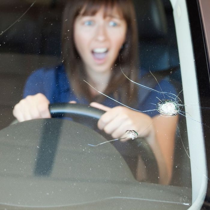 woman surprised at windshield crack