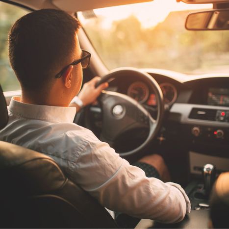 person sitting comfortably in car while driving