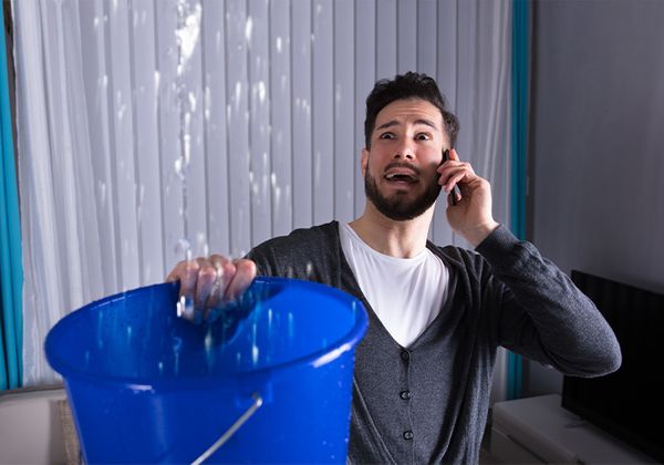 man on phone with emergency plumbing service