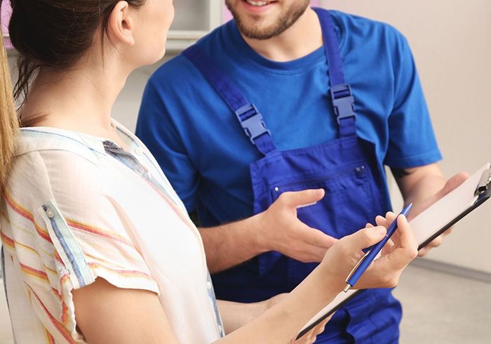 Homeowner talking with plumber Homeowner talking with plumber