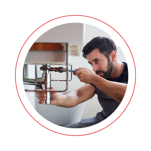 A plumber repairing a sink drain