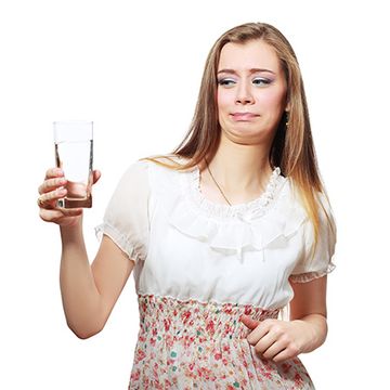 woman disgusted by water in glass