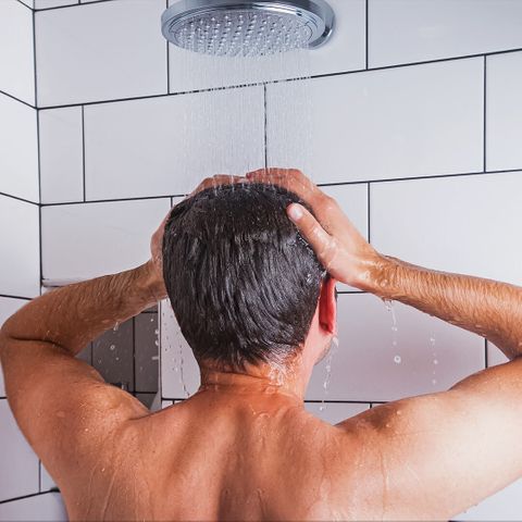 man showering with hot water