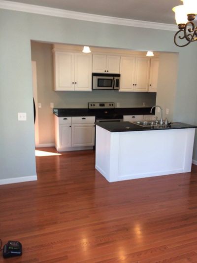 renovated kitchen with white cabinets and granite countertops 491573099_3853798228264738_2298753026465271643_n.jpg