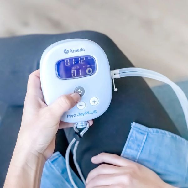 Professional woman using breast pump in an office setting Professional woman using breast pump in an office setting