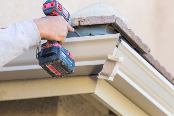 person working on gutter