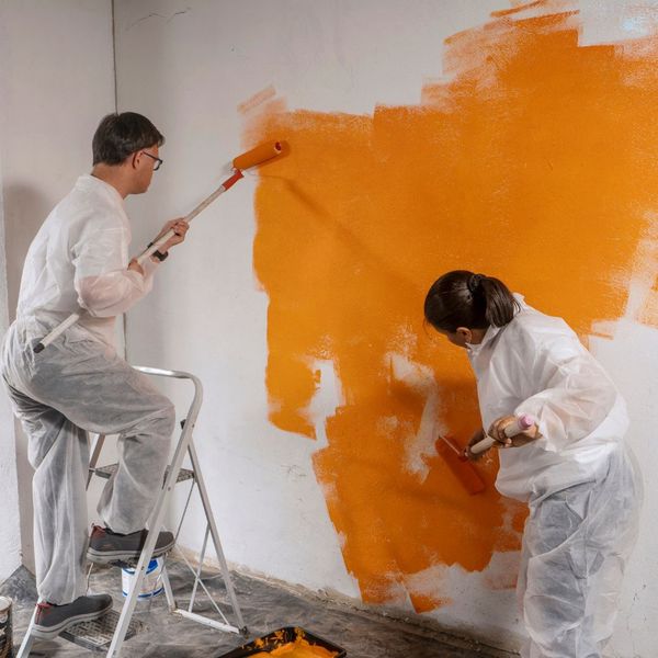 professional painters with oranger paint 